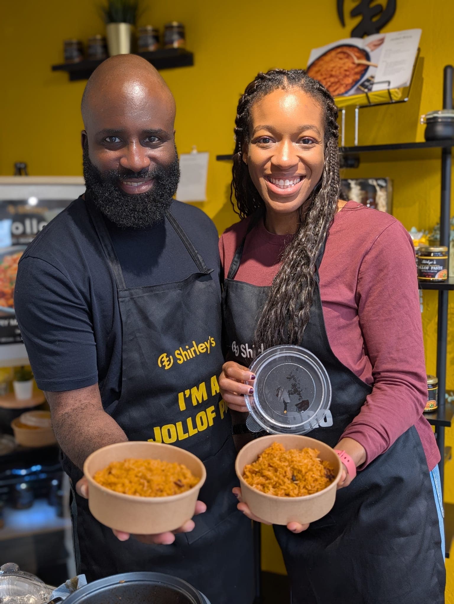 Shirley's cooking class instructors with Jollof rice