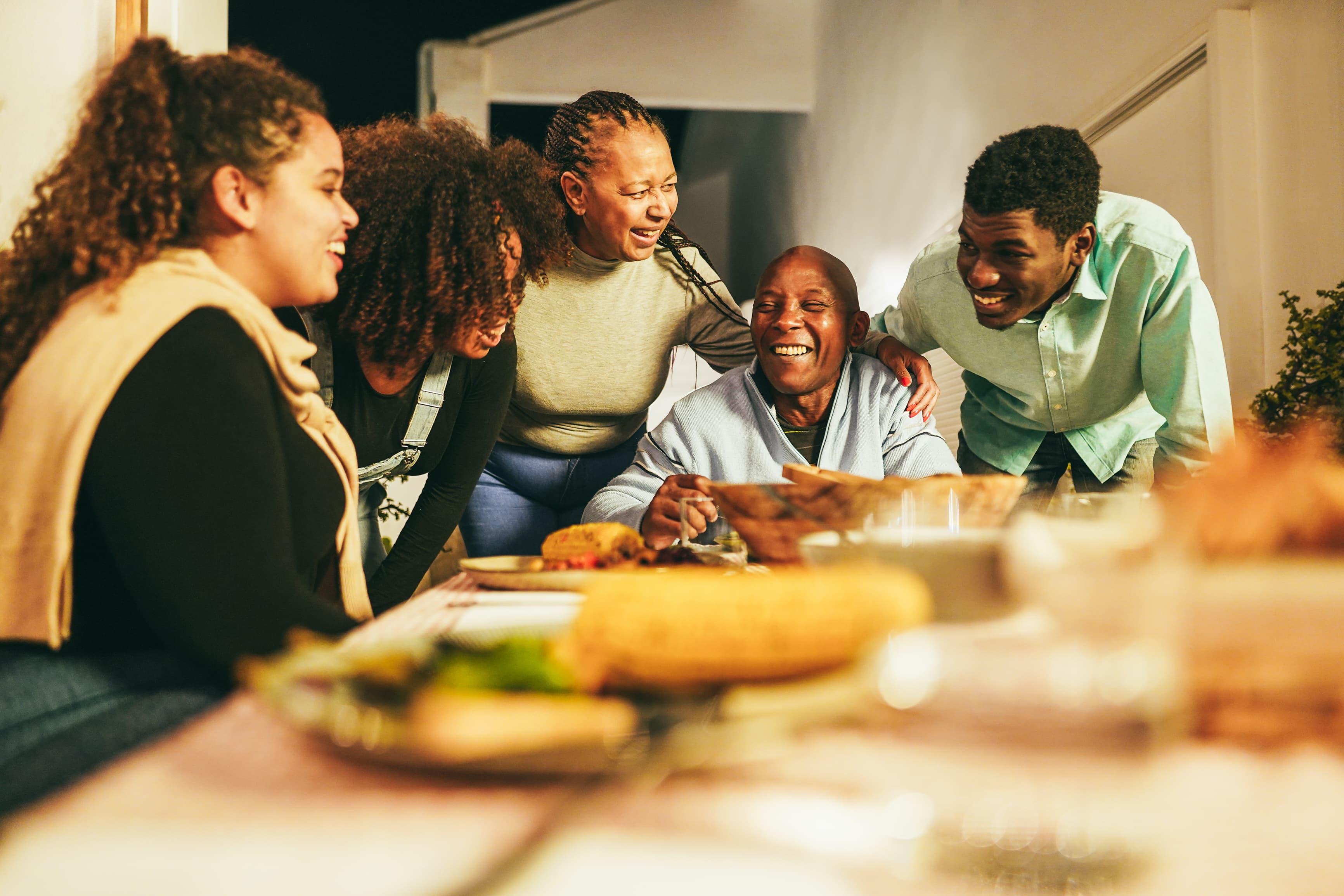 Multi-generational family gathering around dining table