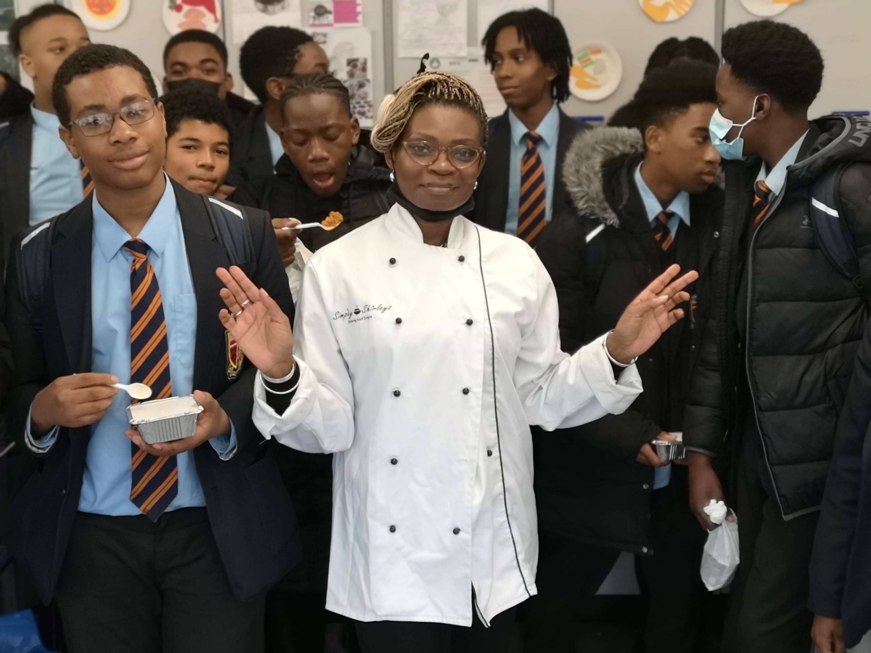 Shirley teaching students in chef's whites